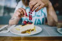 Kaboompics - Woman Enjoying Cheese Cake and a Coffee with Fruits in a Cafeteria