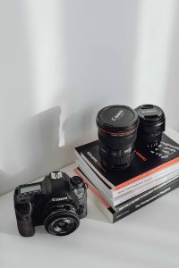 Kaboompics - Photographer's desk - books, DSLR camera and lenses