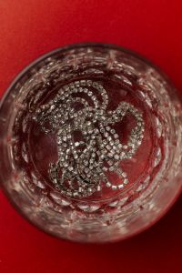 Kaboompics - Silver Sparkle in a Crystal Glass on Red Background