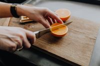Cutting the oranges with knife