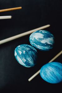 Kaboompics - Woman Painting Blue Easter Eggs