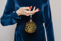 Kaboompics - Woman in Blue Blouse Holds a Christmas Tree Bauble