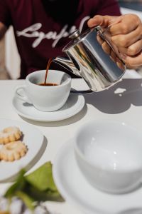 Kaboompics - Pouring coffee into a cup. Silver kettles, Italian cookies.