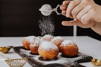 Homemade Polish doughnuts with cherry filling, covered with powdered sugar. Traditional speciality on Fat Thursday in Poland.