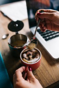 Kaboompics - Woman pours sugar into coffee