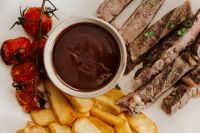 Kaboompics - Classic Steak with Golden Fries and Rich Gravy - Grilled Tomatoes