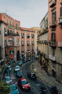 Street with cars and old tenement houses in Naples