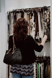 Kaboompics - Woman picks fabric in store