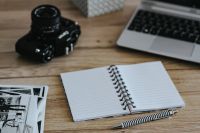 Kaboompics - Black-and-white photos with a silver laptop, a notebook and a camera