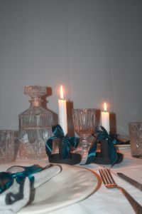 Kaboompics - Elegant Candlelit Table: Crystal Glassware - Satin Bows & Glowing Candles