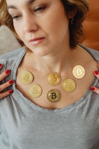 The woman holds a Cryptocurrency Bitcoinf
