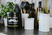 Kaboompics - Kitchen utensils and cans by the wall