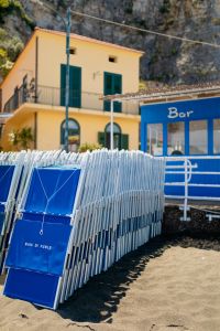 Blue hotel loungers on the beach, Baia di Puolo Hotel