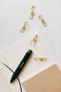 Kaboompics - Pen, clips and notebooks on a white desk