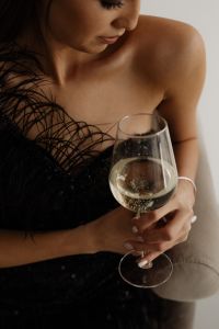 Kaboompics - Classy aesthetics - beautiful Asian woman in black evening dress - white wine in a glass