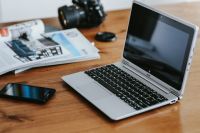 Kaboompics - Silver laptop with a smartphone, a camera and magazines