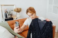Woman takes photos of products she will sell online - dress