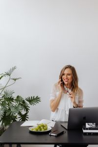 Kaboompics - A businesswoman speaks on the phone at her desk