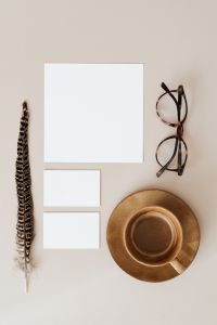 Blank cards & coffee on beige background