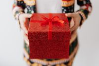 Kaboompics - Close up of man wearing a Christmas suit and hand holding red box