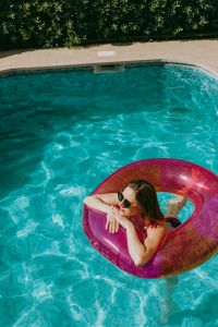 Kaboompics - A beautiful woman in a pool with an inflatable ring