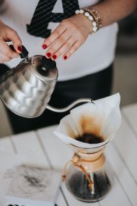 Woman pouring water in Chemex filter coffee maker