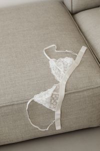 Kaboompics - White lace bra with underwire lies on the sofa