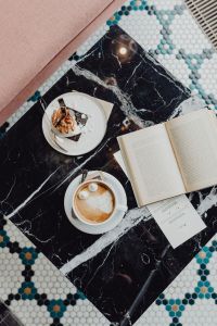 Kaboompics - Book coffee and cake with meringue and whipped cream on black marble