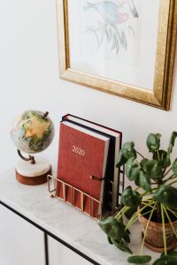 Kaboompics - Planner on The White Marble Table, White Background, Pilea, Globe, Painting on the Wall