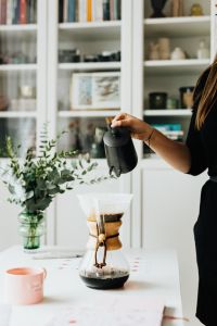 Kaboompics - The woman drinks coffee and works at her desk