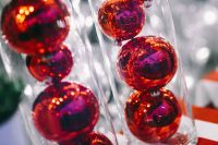 Kaboompics - Red Christmas baubles packed in plastic tubes