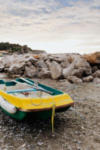 Little yellow green boat on the beach