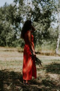 Kaboompics - Woman in a red dress with flowers outdoors