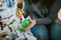 Kaboompics - Woman putting glue on a green egg