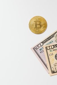 Kaboompics - Golden Bitcoin coin on US Dollars