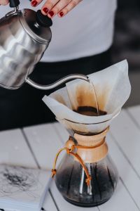 Kaboompics - Woman pouring water in Chemex filter coffee maker