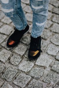 Woman in black sneakers and blue jeans
