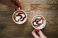 A cups of coffee with heart latte art on top