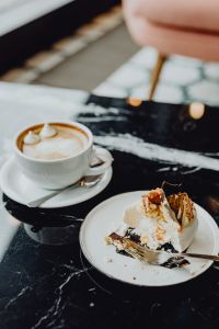 Kaboompics - Coffee and cake with meringue and whipped cream on black marble