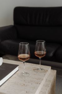 Kaboompics - Two glasses of rose wine on a travertine table