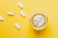 Kaboompics - White pills in yellow bottle