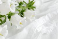 Kaboompics - Mockup photo - white bedding - flowers - blank sheet - square