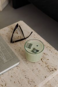 Kaboompics - Travertine Coffee Table with Matcha Latte and Sunglasses - Minimalist Interior