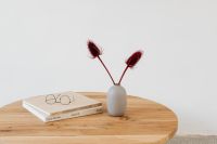 Wooden table - books - glasses - vase with dried flowers