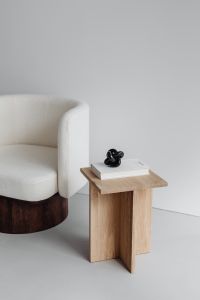 Kaboompics - Modern oak side table - armchair with light boucle fabric - minimalist interior - book