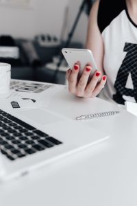 Kaboompics - Businesswoman uses her iPhone mobile at her desk