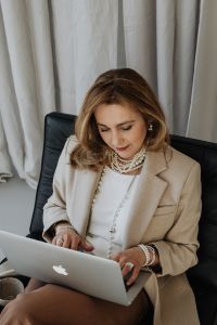 A very elegant and sophisticated woman at work in front of a laptop