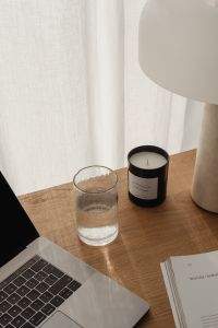 Kaboompics - Travertine lamp - candle - magazine - glass of water