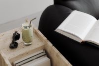 Matcha Latte on Travertine Table Next to Black Leather Sofa - Japandi Style