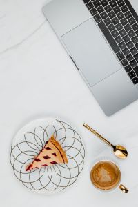 Fresh baked blueberry pie, cup of coffee & laptop